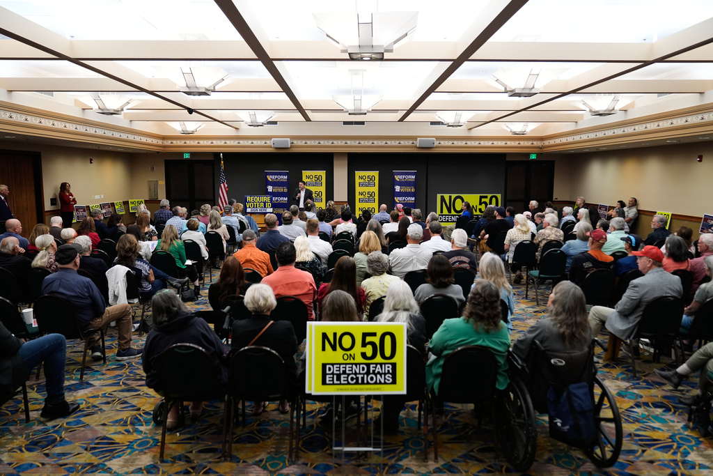 Republican Assembly member Carl DeMaio, center rear, speaks to people attending a No on Prop 50 rally in Redding, Calif., Tuesday, Oct. 21, 2025. (AP Photo/Godofredo A. Vásquez)