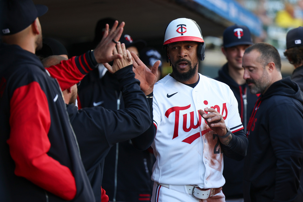 Minnesota Twins' Byron Buxton (25) celebrates in the dugout after scoring during the first inning of a baseball game against the Detroit Tigers Wednesday, April 8, 2026, in Minneapolis. (AP Photo/Ellen Schmidt)