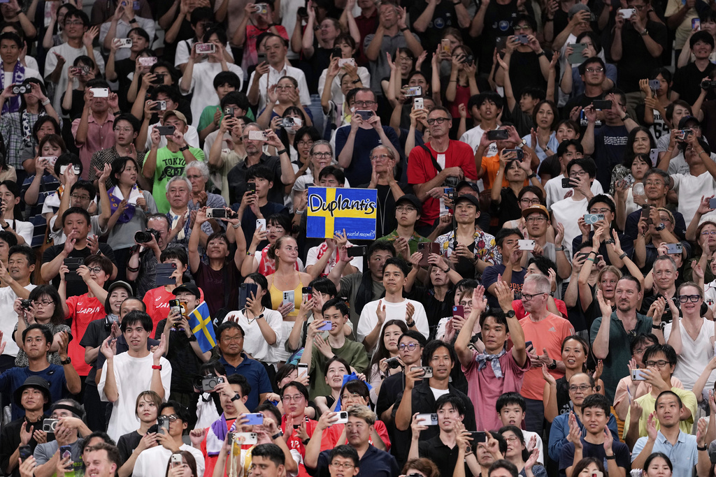 A fan holds a sign for Sweden's Armand Duplantis as he prepares to attempt setting a new men's pole vault world record of 6.30 meters, at the World Athletics Championships in Tokyo, Monday, Sept. 15, 2025. (AP Photo/Matthias Schrader)