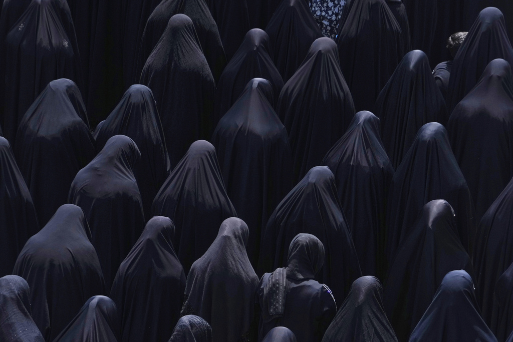 Shiite Muslim women pray at the shrine of Saint Abdulazim in Shahr-e-Ray, south of Tehran, Iran, Aug. 14, 2025, during a ceremony to observe the Arbaeen, which marks the anniversary of the 40th day of mourning following the 7th century death of the Prophet Muhammad's grandson Hussein, who was killed in a battle in Karbala in present-day Iraq. (AP Photo/Vahid Salemi)