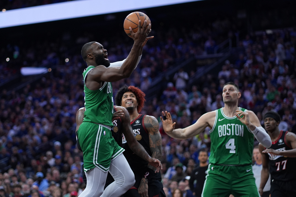 Boston Celtics' Jaylen Brown, left, goes up for a shot past Philadelphia 76ers' Kelly Oubre Jr. during the first half of Game 3 in a first-round NBA playoffs basketball series Friday, April 24, 2026, in Philadelphia. (AP Photo/Matt Slocum)
