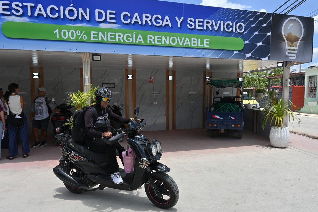 A motorcyclist leaves after recharging his electric bike at a charging station in Santa Clara, Cuba, Saturday, May 2, 2026. (AP Photo/Jorge Luis Banos)