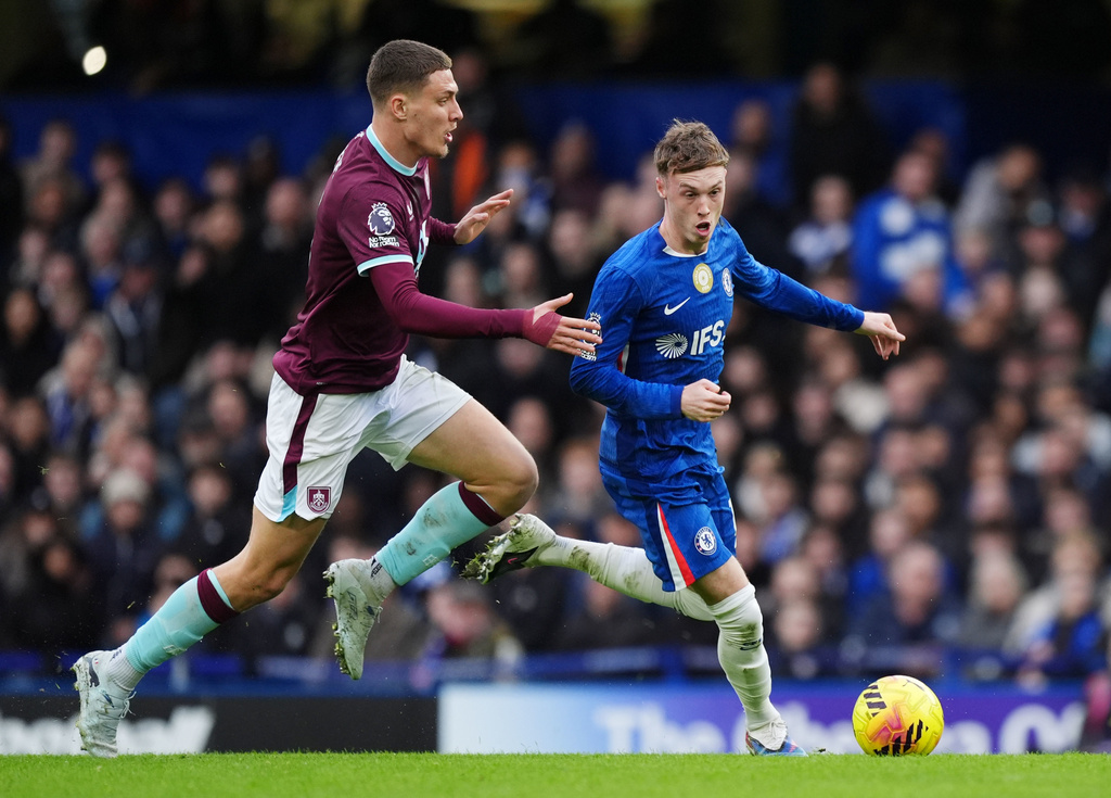 Burnley's Maxime Esteve, left, and Chelsea's Cole Palmer battle for the ball during their English Premier League soccer match in London, Saturday, Feb. 21, 2026. (Ben Whitley/PA via AP)