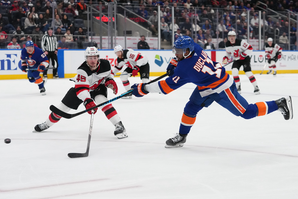 New York Islanders' Anthony Duclair (11) shoots the puck past New Jersey Devils' Colton White (45) for a goal during the first period of an NHL hockey game Tuesday, Jan. 6, 2026, in Elmont, N.Y. (AP Photo/Frank Franklin II)
