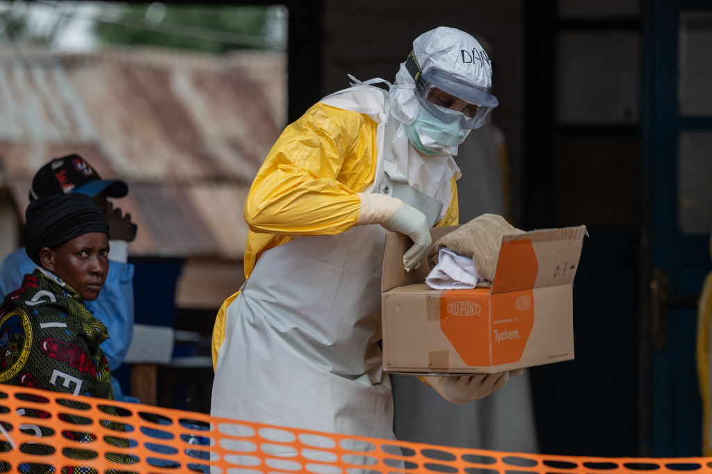 A health worker prepares for duty at the Mongbwalu treatment center in Mongbwalu, Congo, Friday, June 5, 2026. (AP Photo/Moses Sawasawa)