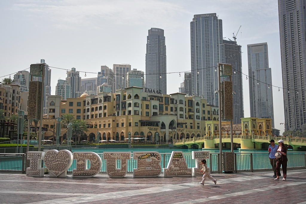 A few people walk in a public plaza in downtown Dubai, United Arab Emirates, Tuesday, March 3, 2026. (AP Photo/ Fatima Shbair)