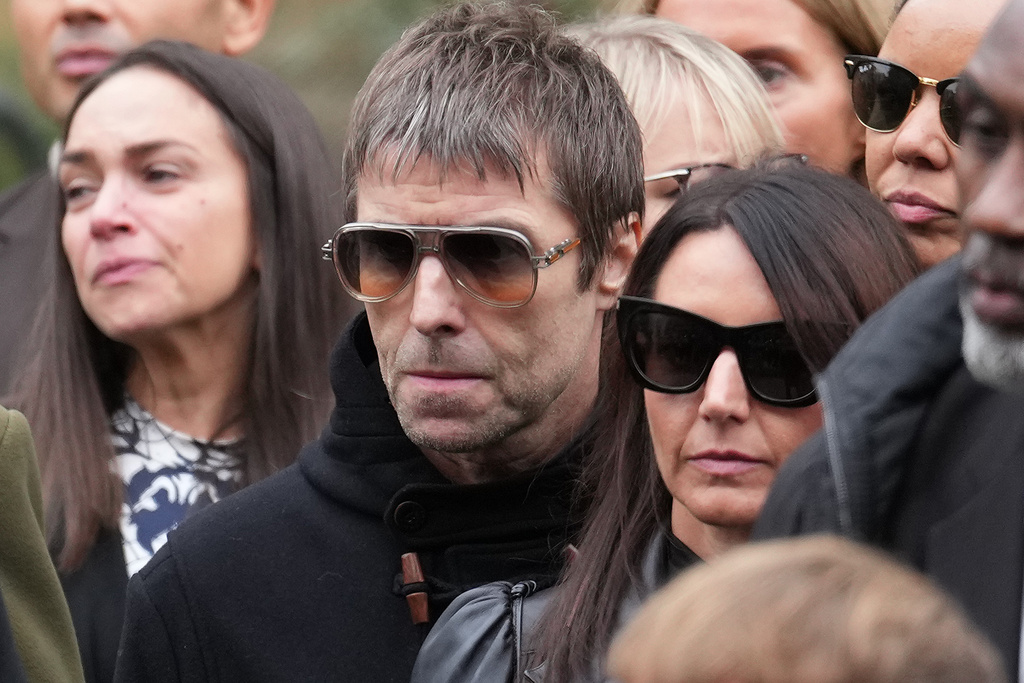 Liam Gallagher, center, of the band Oasis attends the funeral for boxer Ricky Hatton in Manchester, England, Friday, Oct. 10, 2025. (AP Photo/Jon Super)
