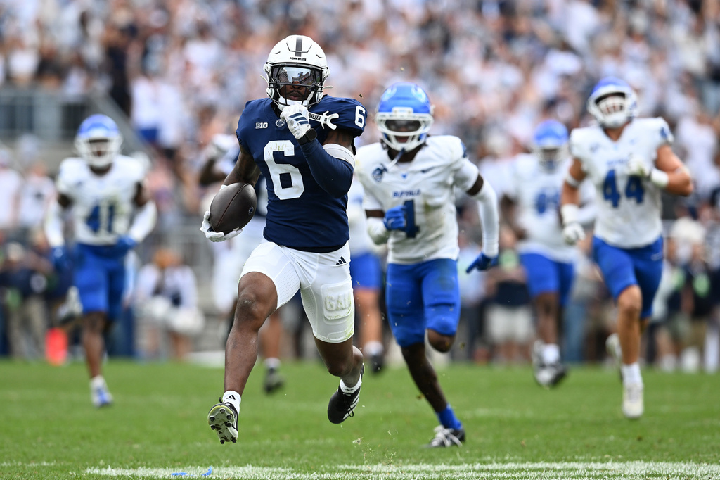 Penn State wide receiver Koby Howard (6) eludes Buffalo safety Ronnell Davis (4) on his way to a touchdown during the second quarter of an NCAA college football game, Saturday, Sept. 19, 2026, in State College, Pa. (AP Photo/Barry Reeger)
