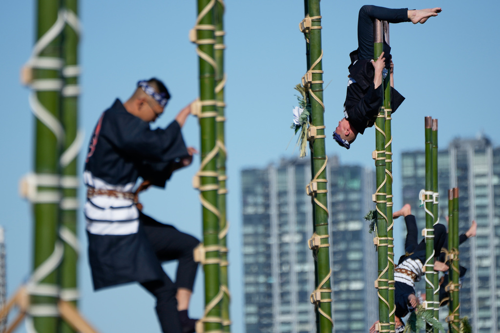 Members of a traditional firefighting preservation group perform ladder stunts during the annual New Year's Fire Brigade Review Tuesday, Jan. 6, 2026, in Tokyo. (AP Photo/Eugene Hoshiko)