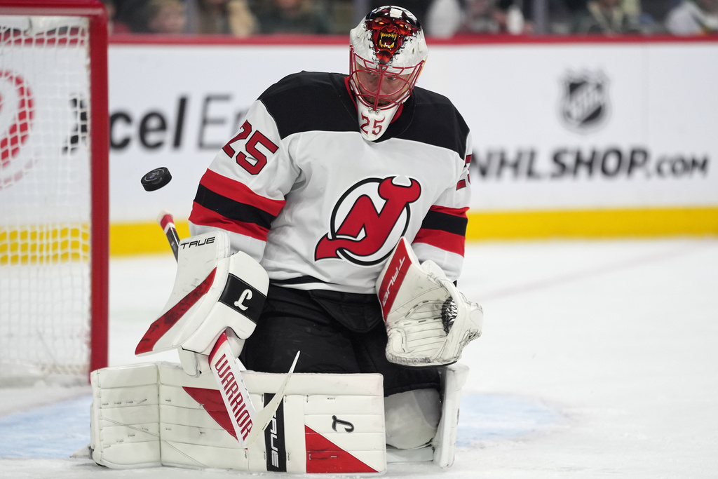 New Jersey Devils goaltender Jacob Markstrom (25) defends against a shot during the first period of an NHL hockey game against the Minnesota Wild, Monday, Jan. 12, 2026, in St. Paul, Minn. (AP Photo/Abbie Parr)