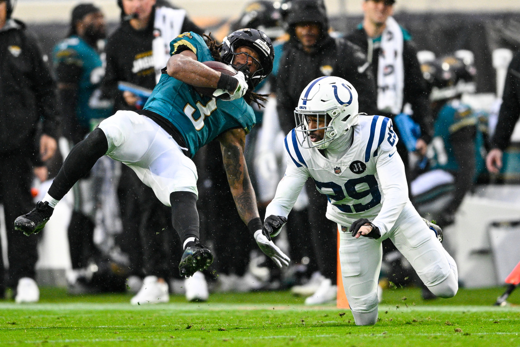 Jacksonville Jaguars wide receiver Jakobi Meyers (3) makes a catch over Indianapolis Colts cornerback Mekhi Blackmon (29) during the second half of an NFL football game, Sunday, Dec. 7, 2025, in Jacksonville, Fla. (AP Photo/Phelan M. Ebenhack)