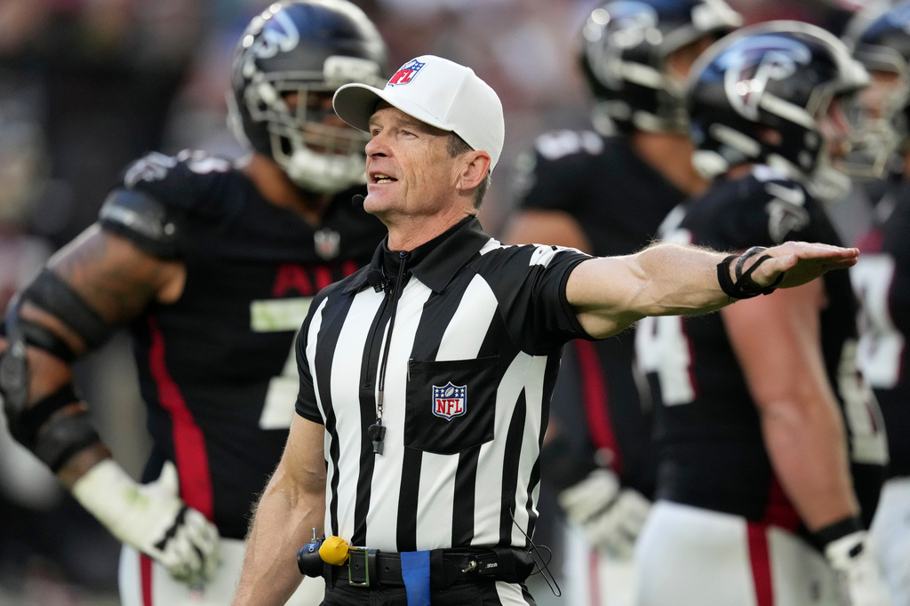 FILE - Referee Land Clark annouces a penalty during the second half of an NFL football game between the Arizona Cardinals and the Atlanta Falcons Sunday, Dec. 21, 2025, in Glendale, Ariz. (AP Photo/Ross D. Franklin, File)