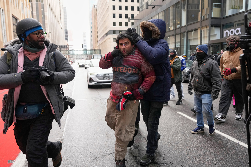 A person tries to forcibly remove a Jake Lang’s supporter’s sweatshirt during an altercation at the March Against Minnesota Fraud rally near Minneapolis City Hall, Saturday, Jan. 17, 2026, in Minneapolis. (AP Photo/Yuki Iwamura)