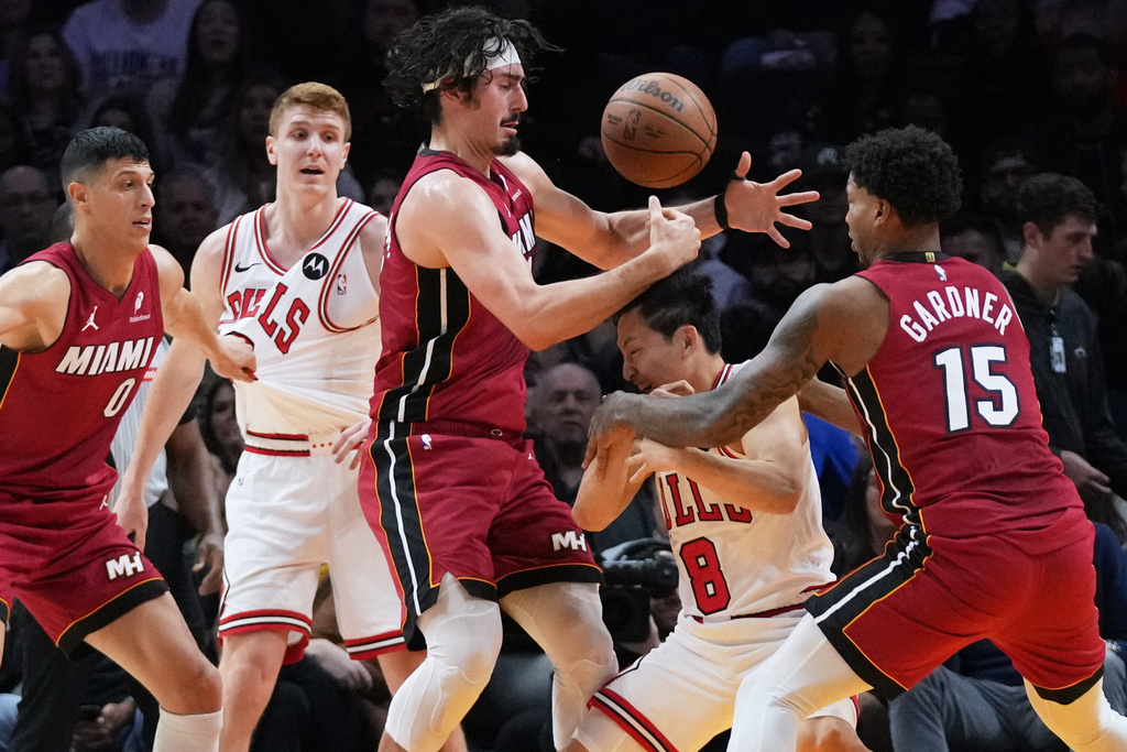 Miami Heat forward Jaime Jaquez Jr., third from left, and forward Myron Gardner (15) defend Chicago Bulls guard Yuki Kawamura (8) during the first half of an NBA basketball game, Saturday, Jan. 31, 2026, in Miami. (AP Photo/Lynne Sladky)