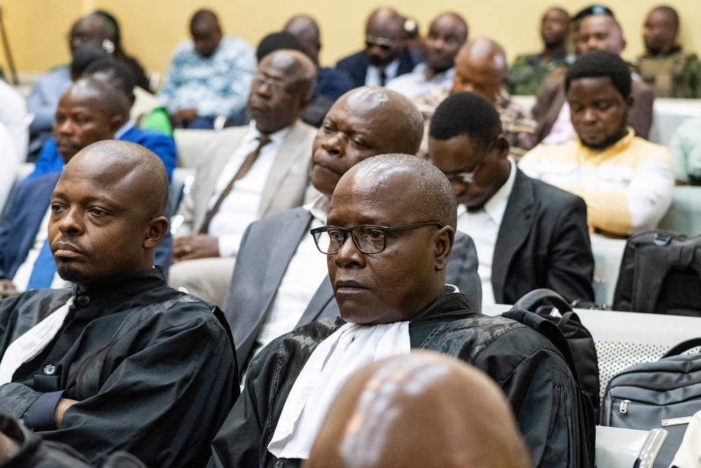 Lawyers and members of the public attend the trial of former Congolese President Joseph Kabila in Kinshasa, Democratic Republic of Congo, Tuesday, Sept. 30, 2025.(AP Photo/ Samy Ntumba Shambuyi)