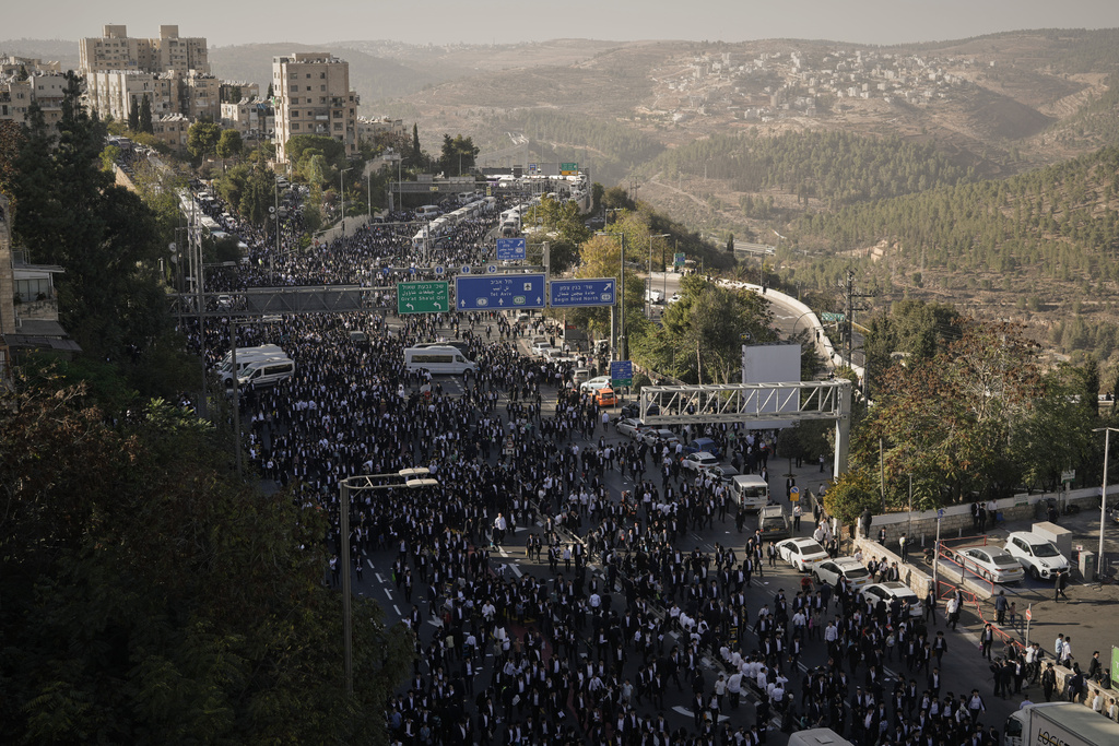 Ultra-Orthodox Jewish men attend a rally against plans to force them to serve in the Israeli military, in Jerusalem, Thursday, Oct. 30, 2025. (AP Photo/Leo Correa)