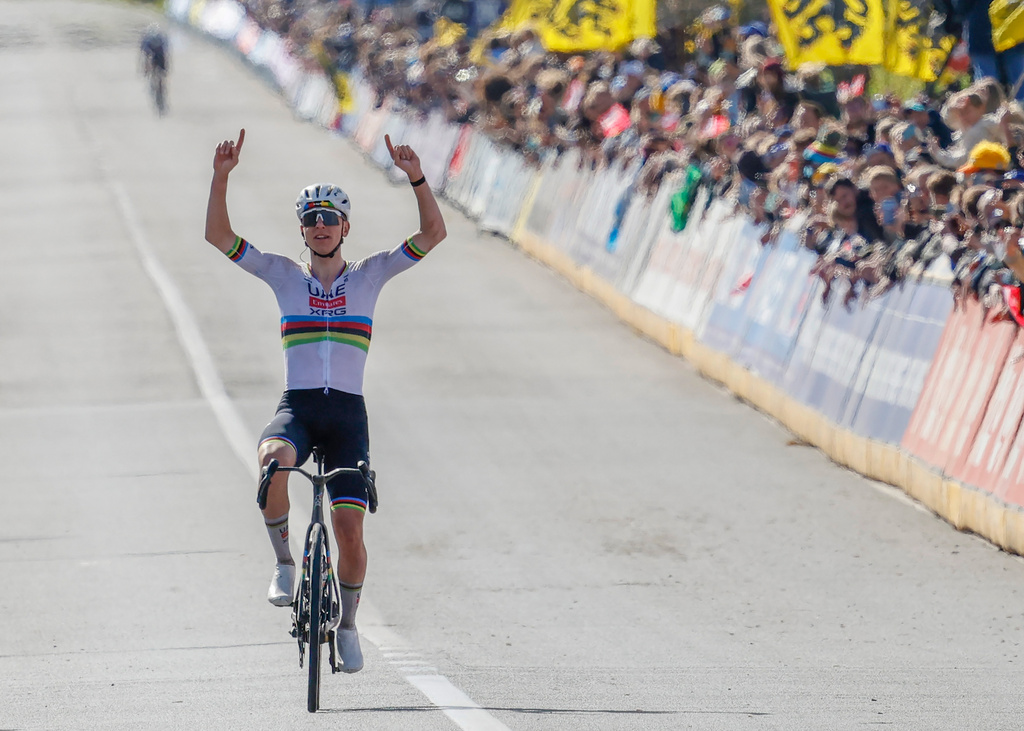 Slovenia's Tadej Pogacar crosses the finish line to win the Tour of Flanders cycling race, in Oudenaarde, Belgium Sunday, April 5, 2026. (AP Photo/Geert Vanden Wijngaert)