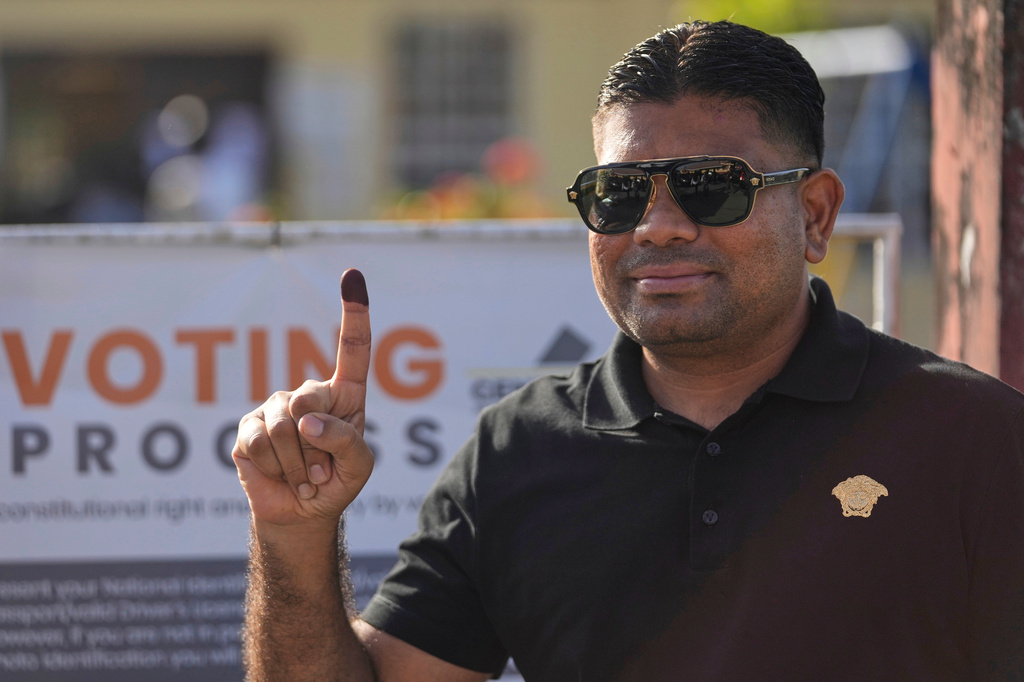 FILE - Presidential candidate Azruddin Mohamed, of the We Invest in Nationhood party, displays his ink-stained finger after voting in general elections in Georgetown, Guyana, on Sept. 1, 2025. (AP Photo/Matias Delacroix, File)