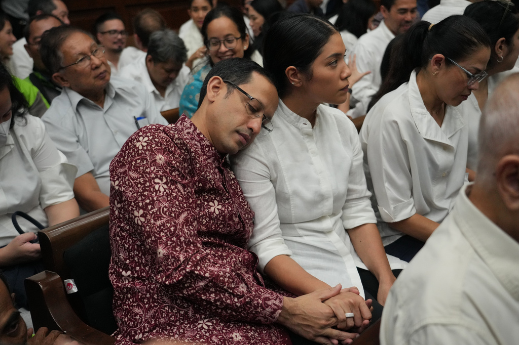 Nadiem Anwar Makarim, the co-founder of Indonesia's payments platform and ride hailing company Gojek and former education minister, sits next to his wife Franka Franklin Makarim before the start of his trial hearing at the Corruption Court in Jakarta, Indonesia Wednesday, May 13, 2026. (AP Photo/Tatan Syuflana)