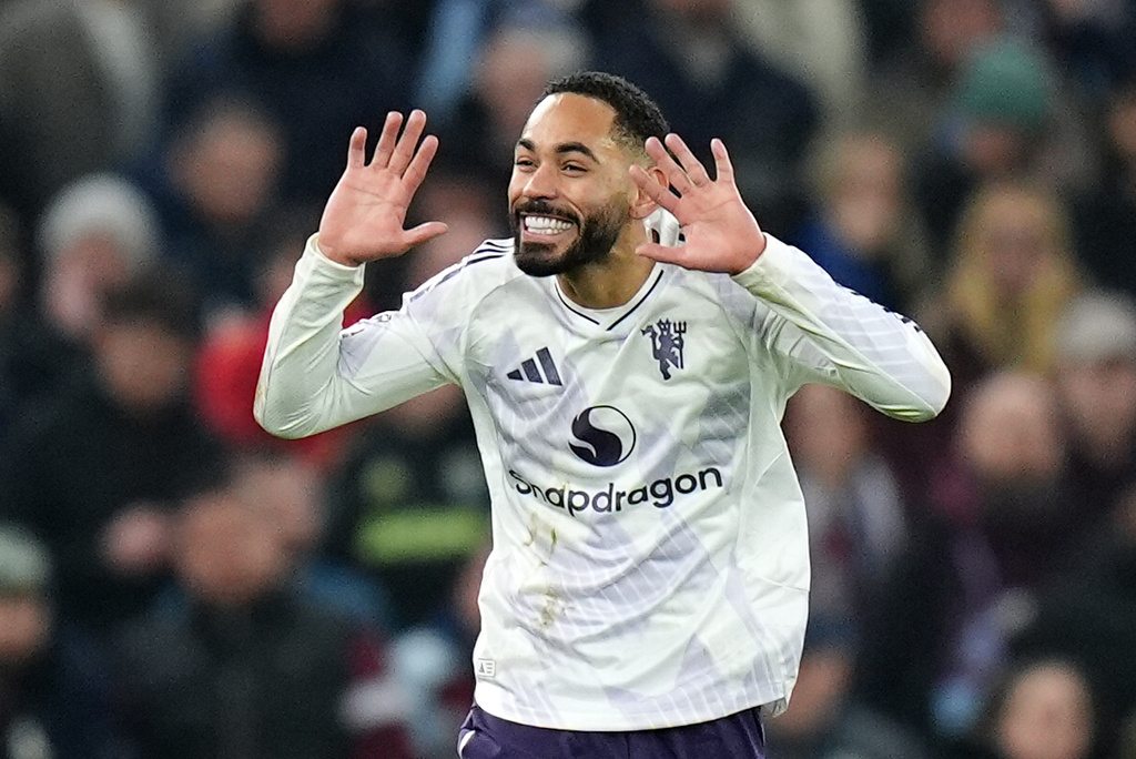 Manchester United's Matheus Cunha celebrates scoring their side's first goal of the game during the Premier League soccer match between Aston Villa and Manchester United, in Birmingham, England, Sunday Dec. 21, 2025. (Jacob King/PA via AP)