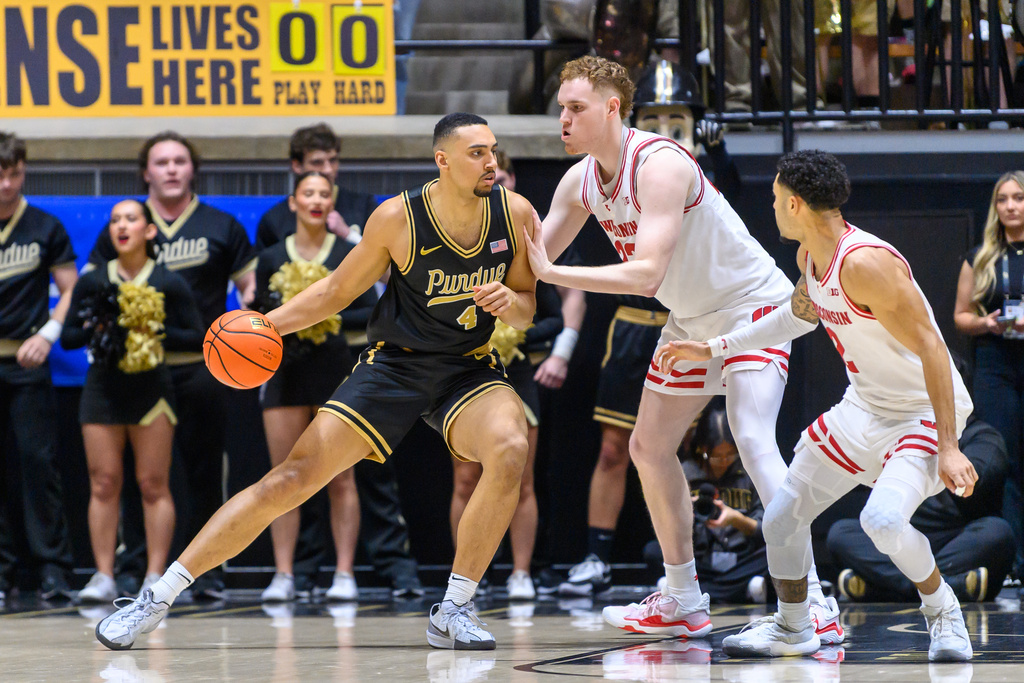 Purdue's Trey Kaufman-Renn drives as Wisconsin's Austin Rapp, left, and Nick Boyd, right, defend during the first half of an NCAA college basketball game Saturday, March 7, 2026, in West Lafayette, Ind. (AP Photo/Craig Pessman)