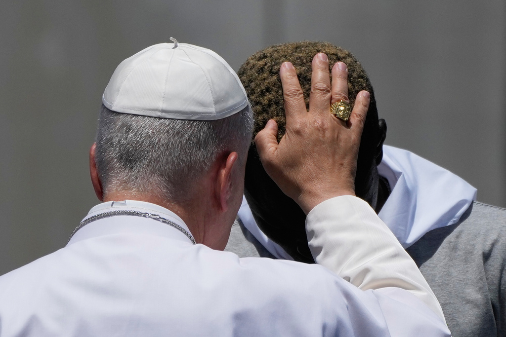 Pope Leo XIV blesses a migrant during a meeting with organizations working with migrants in Arguineguin at the Canary Islands, Spain, Thursday, June 11, 2026. (AP Photo/Alessandra Tarantino)