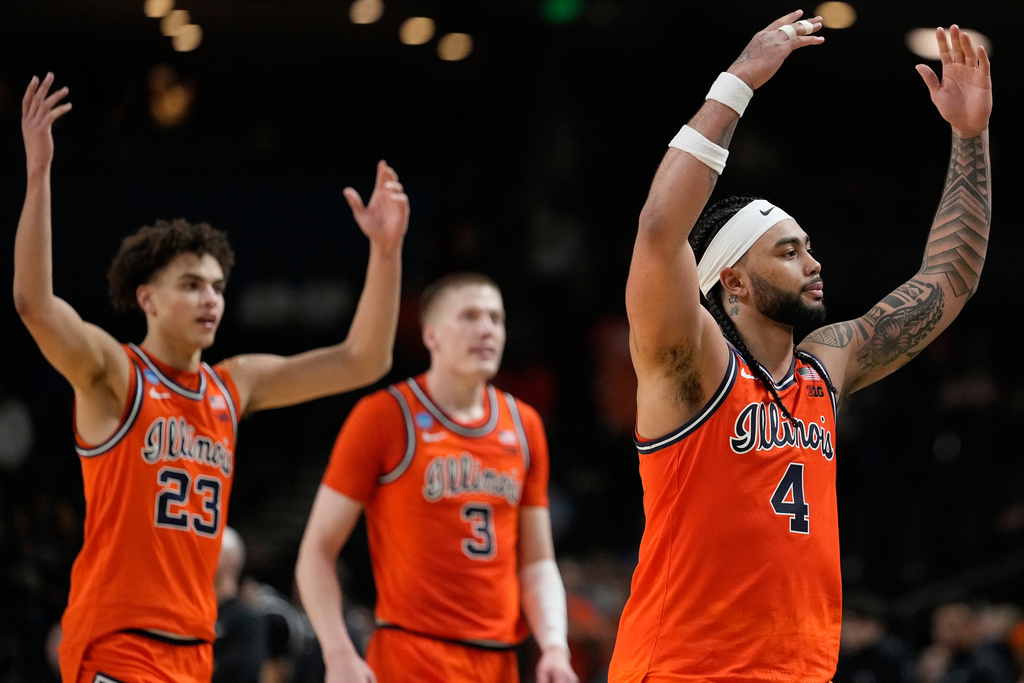 Illinois guard Kylan Boswell (4) and Illinois guard Keaton Wagler (23) celebrate a win against VCU during the second half in the second round of the NCAA college basketball tournament, Saturday, March 21, 2026, in Greenville, S.C. (AP Photo/Brynn Anderson)