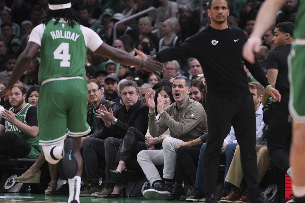 FILE - Boston Celtics owner Bill Chisholm, seated right, applauds during the first half in game 2 of a first-round NBA playoff basketball series against the Orlando Magic, Wednesday, April 23, 2025, in Boston. (AP Photo/Charles Krupa, File)