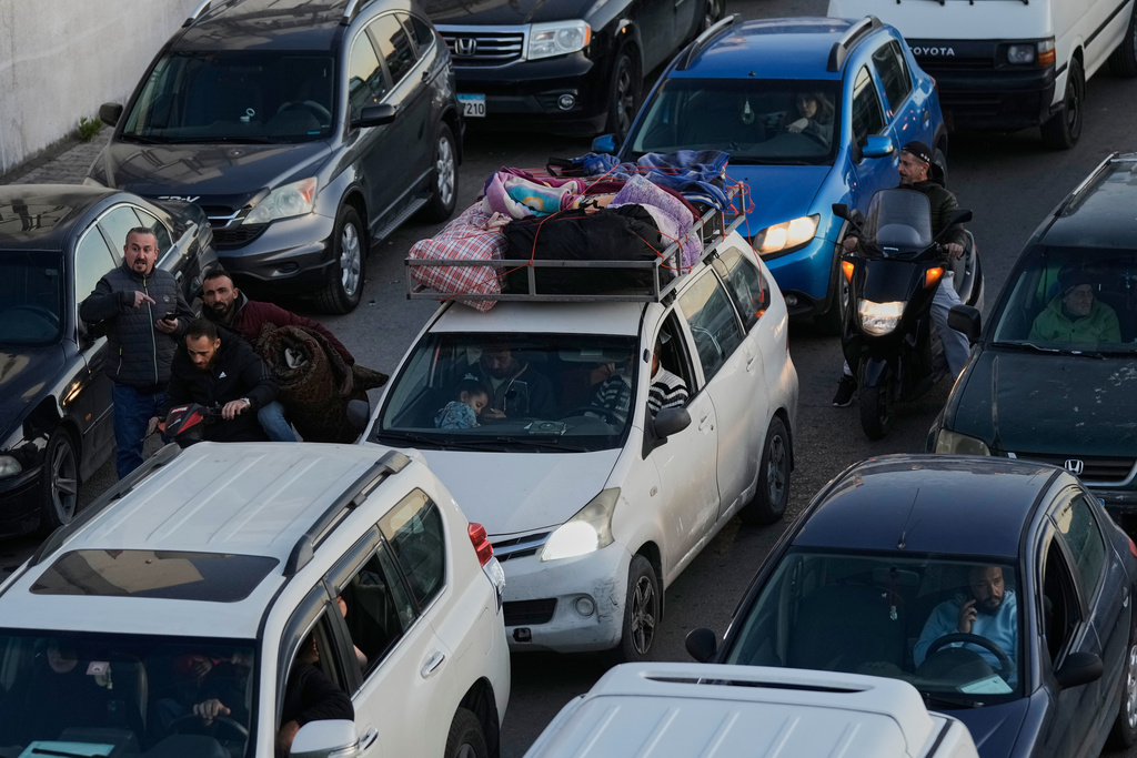 Displaced people fleeing Israeli airstrikes in Dahiyeh, Beirut's southern suburbs, sit in traffic on a highway in Beirut, Lebanon, Thursday, March 5, 2026. (AP Photo/Bilal Hussein)