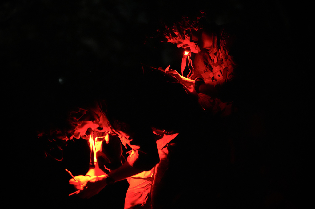 A cadet uses another cadet's back to plot points on a map before competing in night land navigation during the Sandhurst Military Skills Competition at the United States Military Academy in West Point, N.Y., Friday, May 1, 2026. (AP Photo/Julia Demaree Nikhinson)