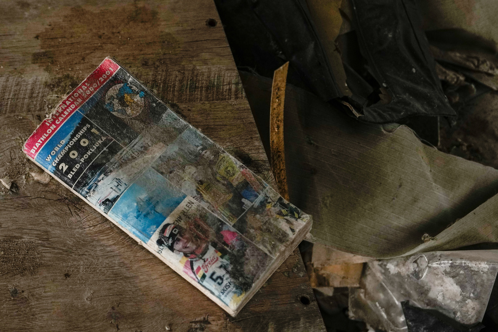 A 2001 Biathlon World Championships brochure lays in the rubble of the Chernihiv, Ukraine ski base, which was destroyed following Russian attacks in 2022, Thursday, Oct. 30, 2025. (AP Photo/Julia Demaree Nikhinson)