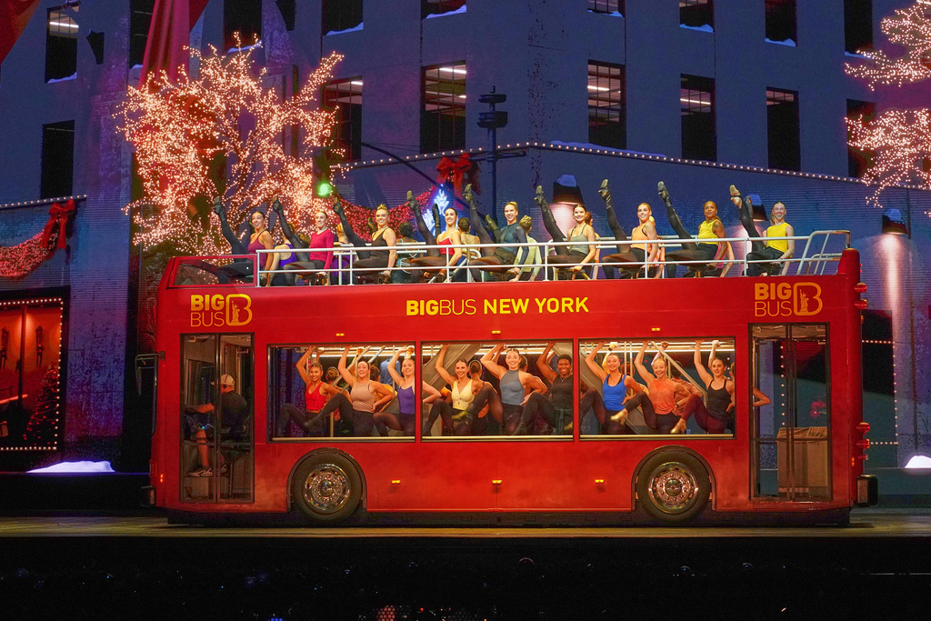 The Rockettes rehearse aboard a double-decker sightseeing bus in the Christmas Spectacular at Radio City Music Hall, in New York, Thursday, Oct. 30, 2025. (AP Photo/Richard Drew)