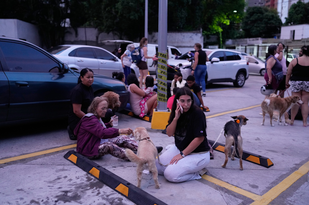 People stay outside their homes after an earthquake in Caracas, Venezuela, Wednesday, June 24, 2026. (AP Photo/Ariana Cubillos)