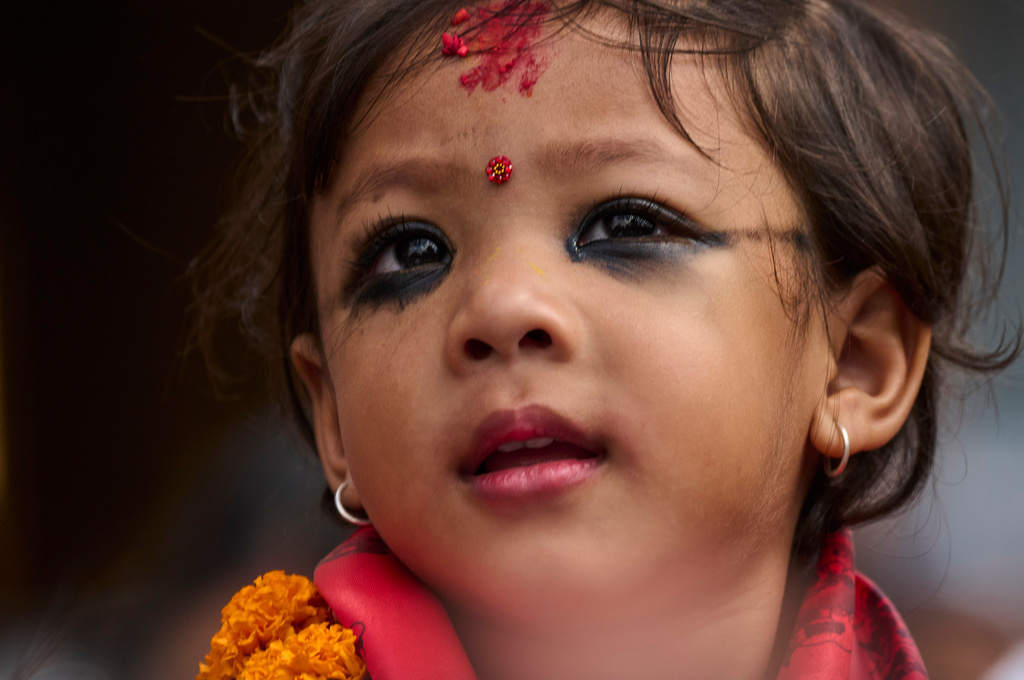 Nepal's newly appointed living goddess, Kumari Aryatara Shakya, is carried toward Kumari Ghar, the temple palace where she will be residing in Kathmandu, Nepal, Tuesday, Sept. 30, 2025. (AP Photo/Niranjan Shrestha)