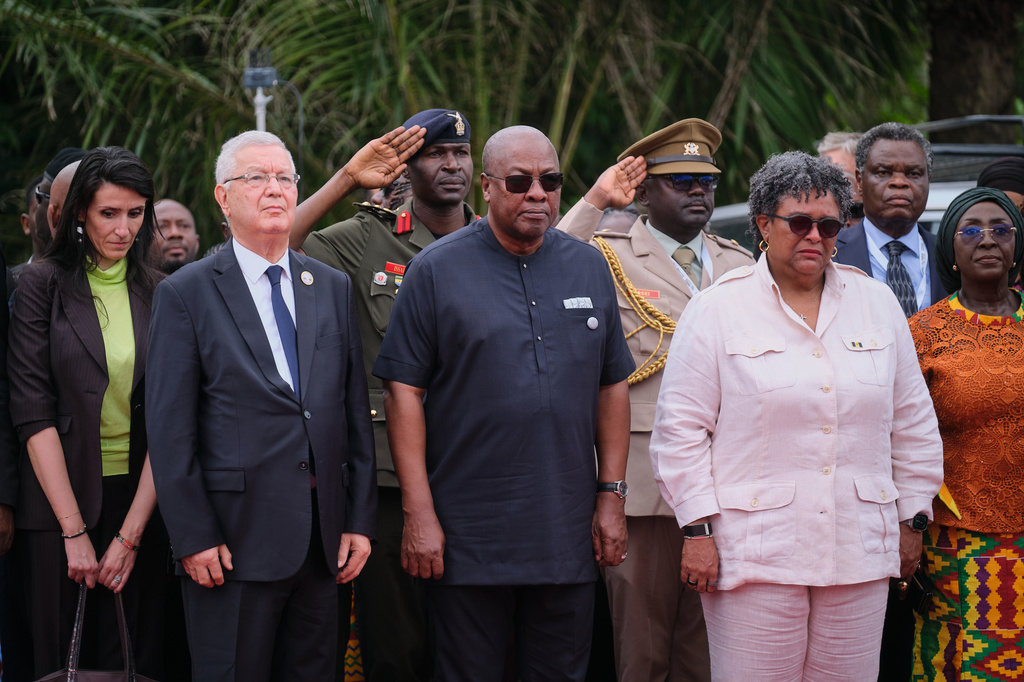 President John Dramani Mahama, center, Barbados Prime Minister Mia Amor Mottley, right, and other dignitaries attend a wreath-laying ceremony to honor victims of the transatlantic slave trade at Christiansborg Castle during a Juneteenth commemoration ceremony in Accra, Ghana, Friday, June 19, 2026. (AP Photo/Reuben Ekow Quansah)