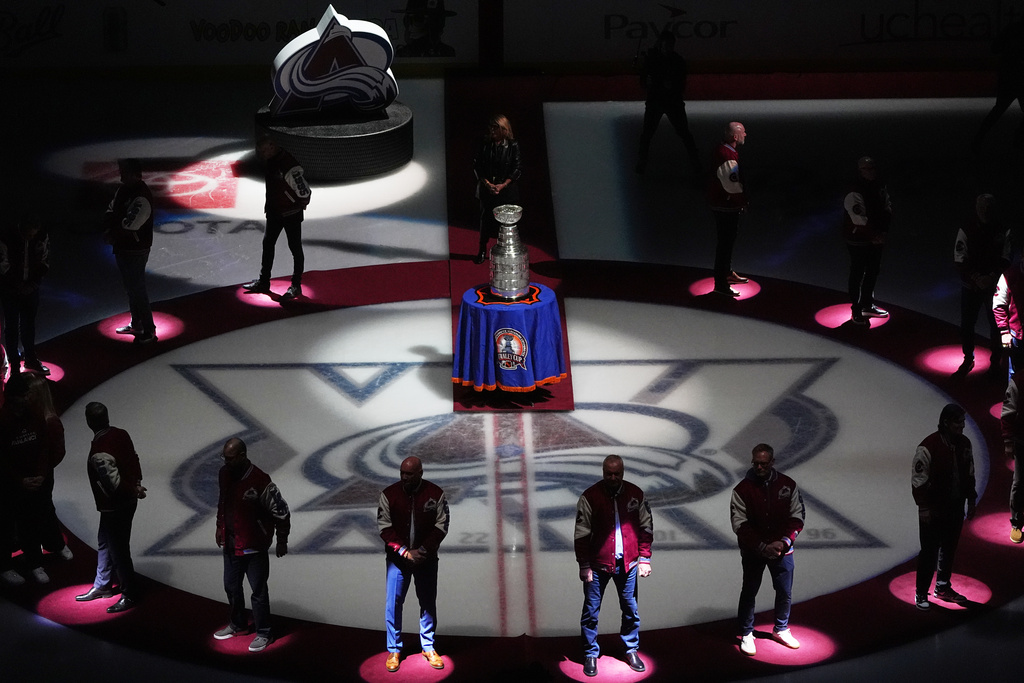 Members of the 1996 Stanley Cup Championship team from the Colorado Avalanche are honored to mark the 30th anniversary of winning the Cup before an NHL hockey game against the Florida Panthers Thursday, Dec. 11, 2025, in Denver. (AP Photo/David Zalubowski)