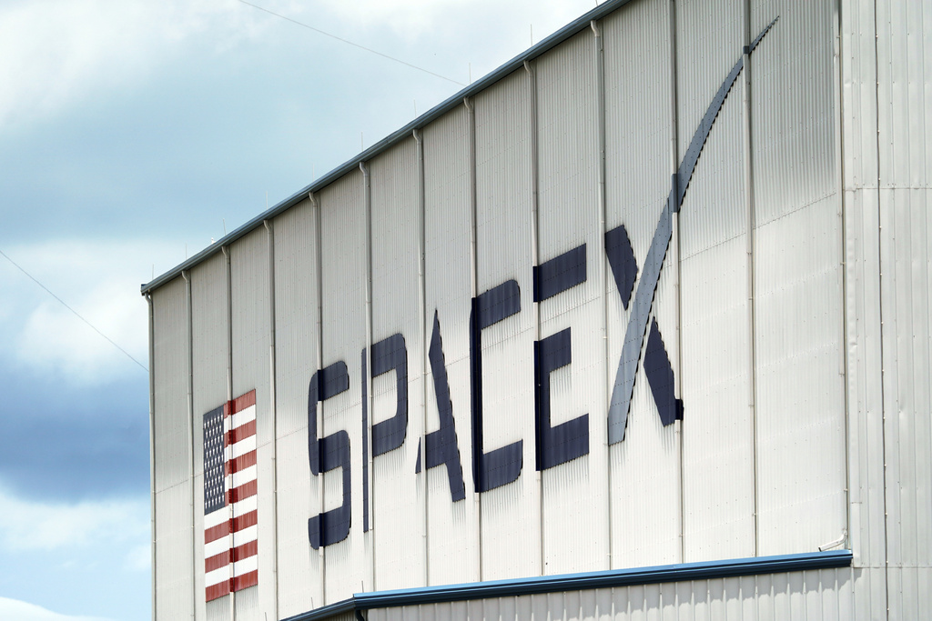 FILE - A SpaceX logo is displayed on a building on May 26, 2020, at the Kennedy Space Center in Cape Canaveral, Fla. (AP Photo/David J. Phillip, File)