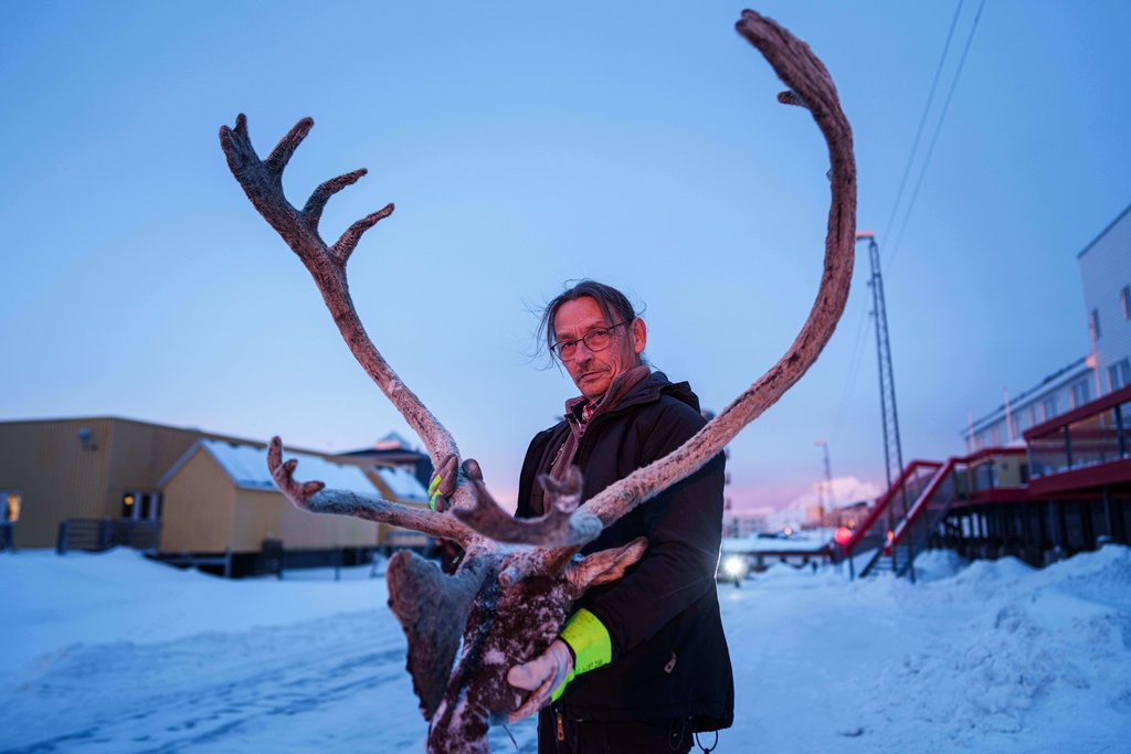 John Hansen, 61, holds a reindeer's head with antlers in Nuuk, Greenland, on Wednesday, Jan. 21, 2026. (AP Photo/Evgeniy Maloletka)