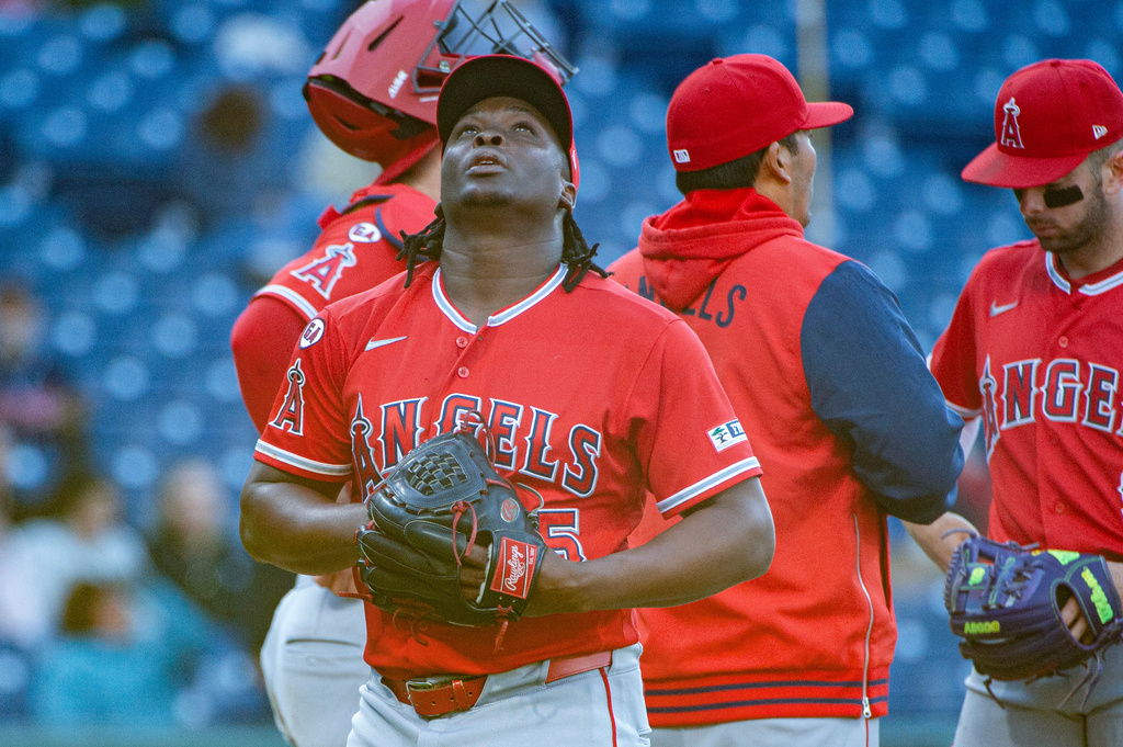 Los Angeles Angels relief pitcher Jose Fermin reacts after being removed by manager Kurt Suzuki during the third inning of a baseball game against the Cleveland Guardians, Monday, May 11, 2026, in Cleveland. (AP Photo/Phil Long)
