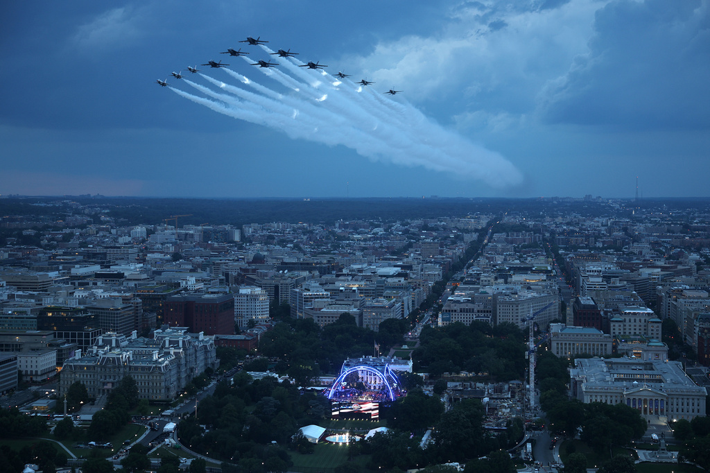 U.S. Air Force Thunderbirds and the U.S. Navy Blue Angels perform a flyover during the National Anthem at UFC Freedom 250 on the South Lawn of the White House on Sunday, June 14, 2026, in Washington. (Win McNamee/Pool Photo via AP)