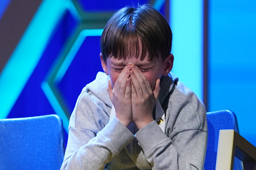 Logan Bailey, 12, of Houston, Texas, reacts during the final round of the 2026 Scripps National Spelling Bee in Washington, Thursday, May 28, 2026. (AP Photo/Allison Robbert)