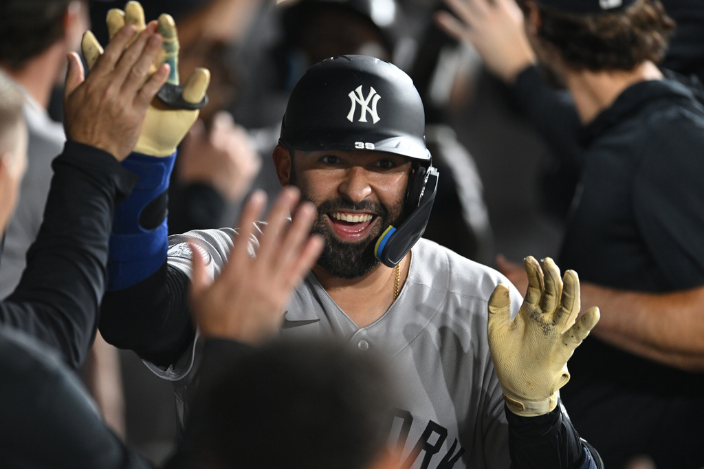 New York Yankees' Ali Sanchez celebrates with teammates in the dugout after hitting a three-run home run during the eighth inning of a baseball game against the Chicago White Sox in Chicago, Monday, July 27, 2026. (AP Photo/Paul Beaty)