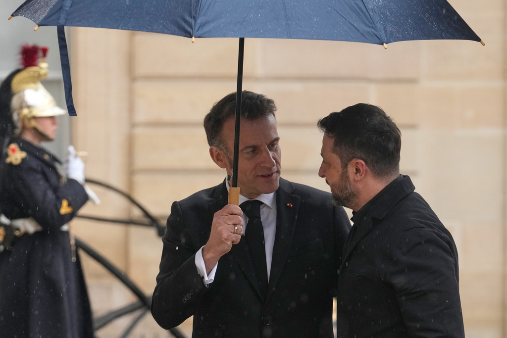 France's President Emmanuel Macron, left, welcomes Ukrainian President Volodymyr Zelenskyy prior to a meeting at the Elysee Palace, Friday, March 13, 2026, in Paris, France. (AP Photo/Michel Euler)
