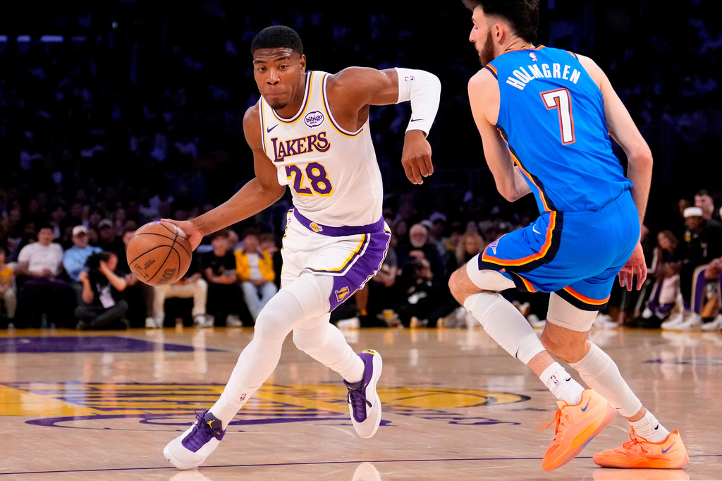 FILE - Los Angeles Lakers forward Rui Hachimura, left, drives by Oklahoma City Thunder center Chet Holmgren during the first half of Game 3 in a second-round NBA basketball playoffs series May 9, 2026, in Los Angeles. (AP Photo/Mark J. Terrill, File)