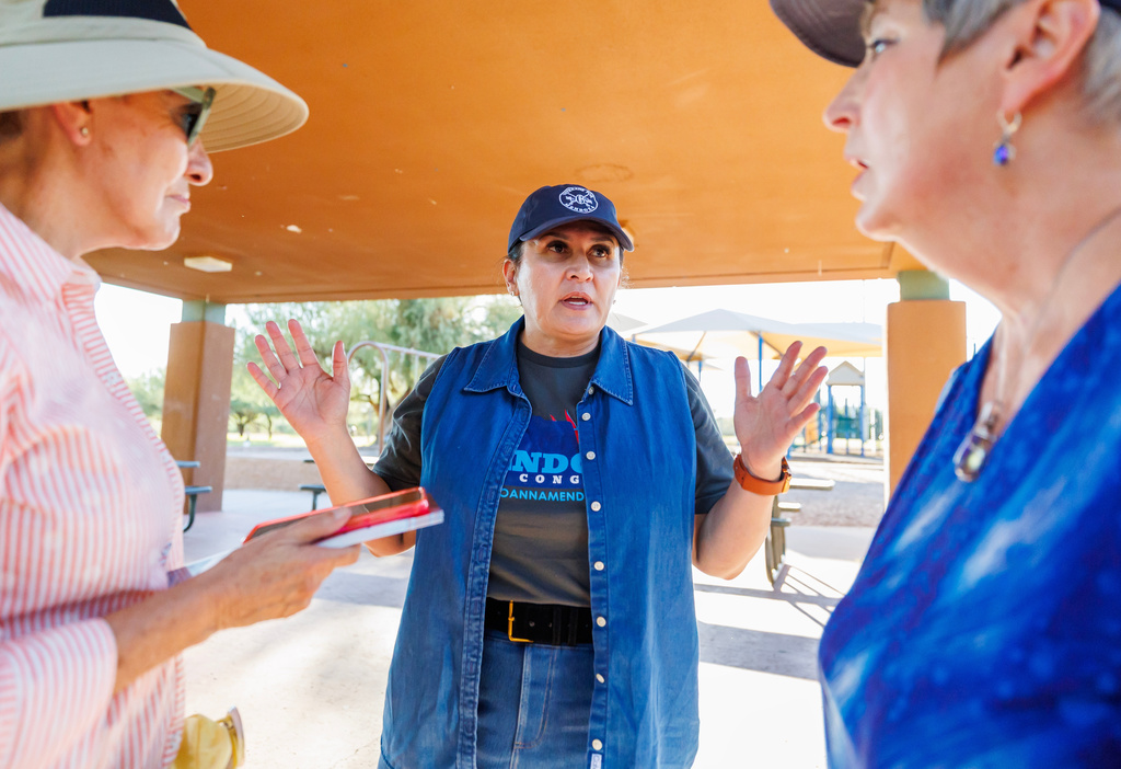 JoAnna Mendoza (D), an Arizona Congressional District 6 candidate, center, talks with campaign volunteers before a weekly neighborhood canvass, Thursday, Oct. 15, 2026, in Oro Valley, Ariz. (AP Photo/Mike Christy)
