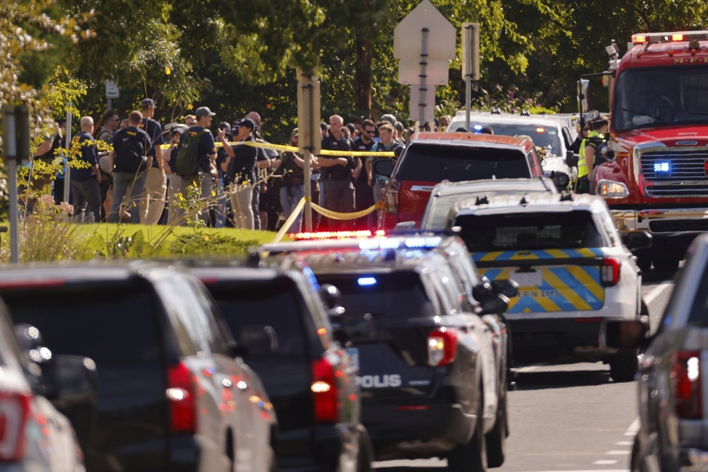 Law enforcement officers gather outside the Annunciation Church's school in response to a reported mass shooting, Wednesday, Aug. 27, 2025, in Minneapolis. (AP Photo/Bruce Kluckhohn)