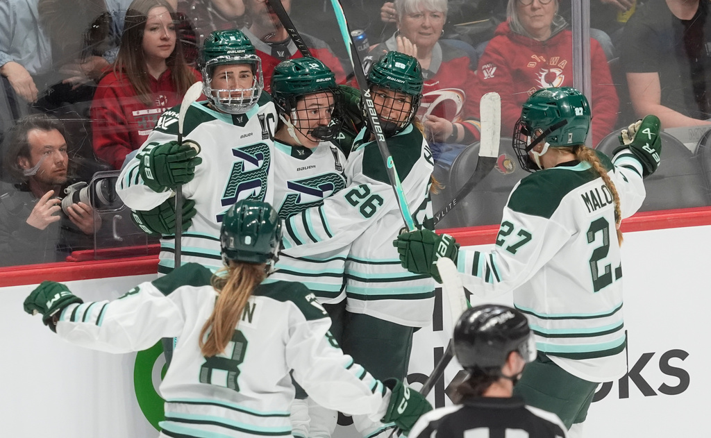 Boston Fleet's Liz Schepers, center rear, celebrates her goal against the Ottawa Charge with Haley Winn (8), Megan Keller, back left, Ella Huber (26) and Shay Maloney (27) during the second period of an PWHL hockey playoff game in Ottawa, Ontario, Friday, May 8, 2026. (Adrian Wyld/The Canadian Press via AP)