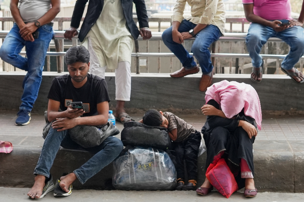 Passengers wait at the Hazrat Shahjalal International Airport after several flights were cancelled or delayed due to the US-Israeli attack on Iran, in Dhaka, Bangladesh, Sunday, March 1, 2026. (AP Photo/Al-emrun Garjon)