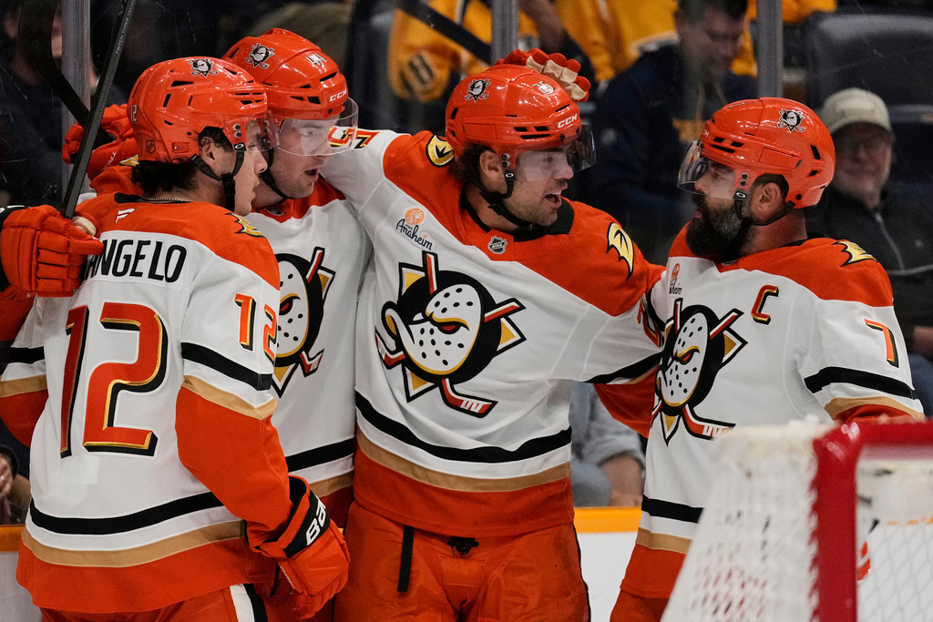 Anaheim Ducks left wing Ross Johnston, second from left, celebrates his goal with right wing Sam Colangelo (12), center Ryan Poehling, second from right, and defenseman Radko Gudas (7) during the first period of an NHL hockey game against the Nashville Predators, Tuesday, Oct. 21, 2025, in Nashville, Tenn. (AP Photo/George Walker IV)