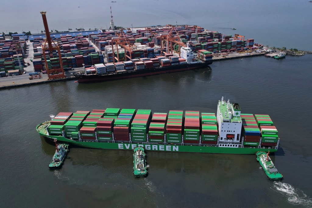 FILE - Tugboats assist a container ship as it prepares to dock at the Manila International Container Terminal at the Philippine capital April 8, 2025. (AP Photo/Aaron Favila, File)